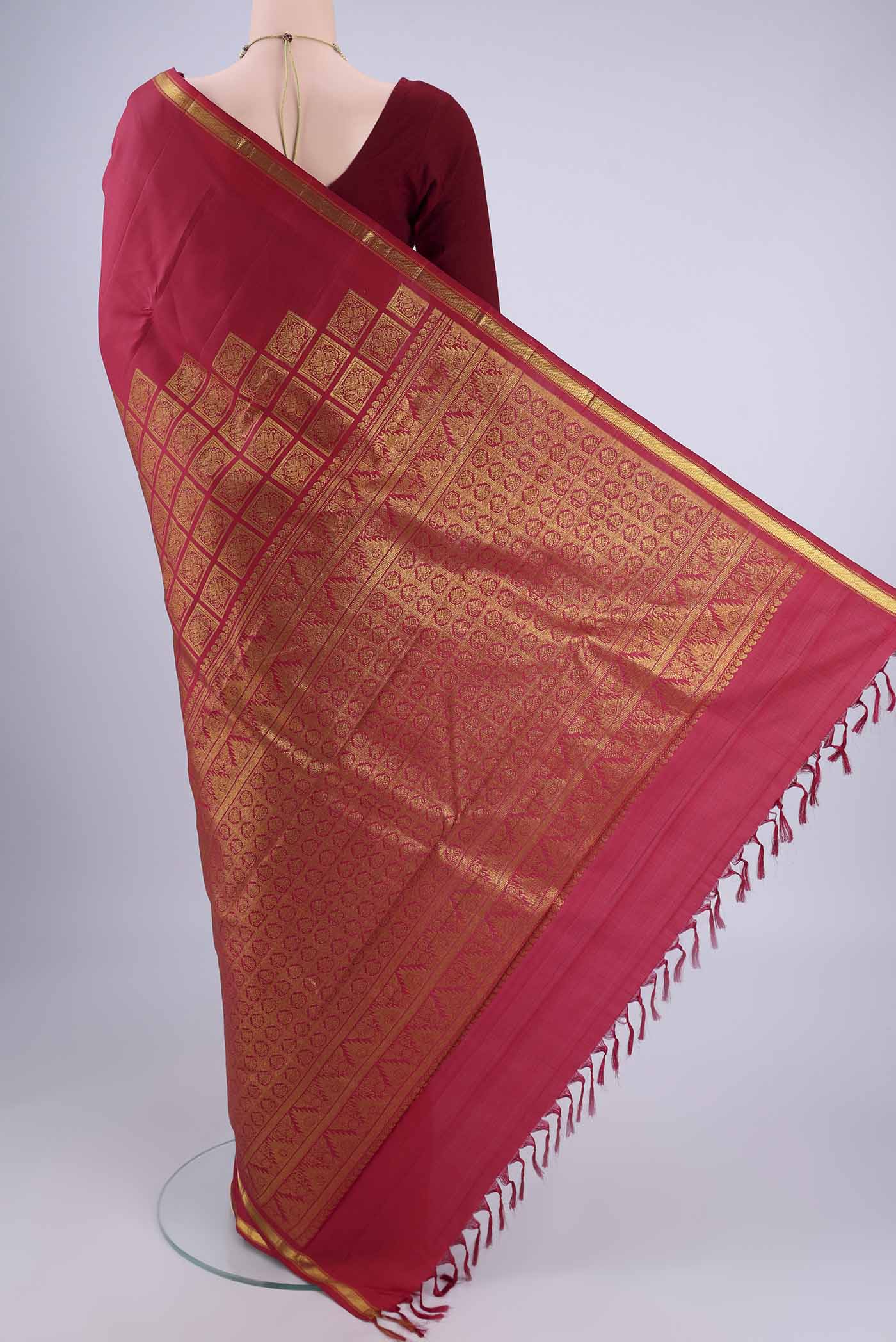 Flat view of Red Kanjivaram Silk Saree with Plain Body and Zari Border. 