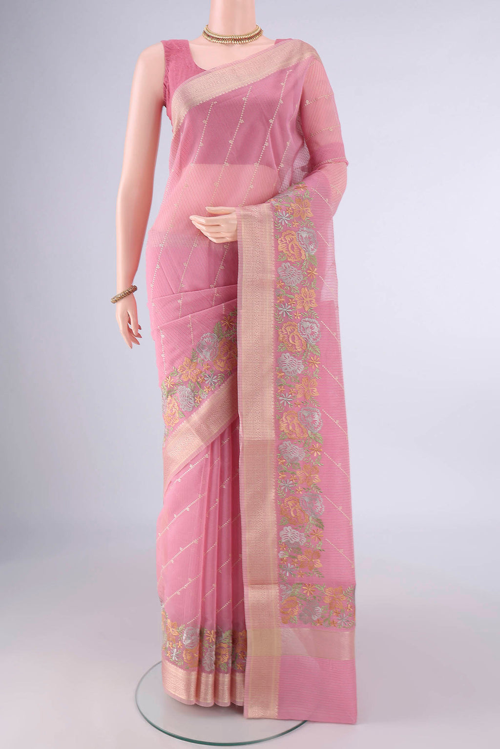 Peach Kota Cotton Saree with Embroidery on the body and Zari And Thread Border.  displayed on a mannequin