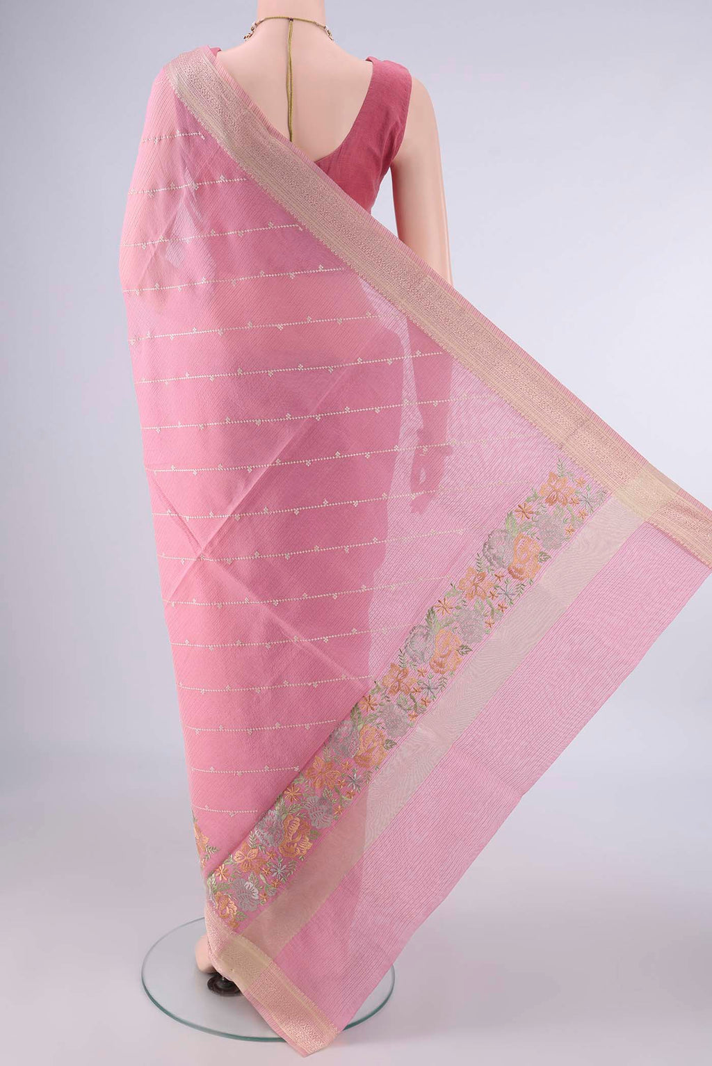 Flat view of Peach Kota Cotton Saree with Embroidery on the body and Zari And Thread Border. 