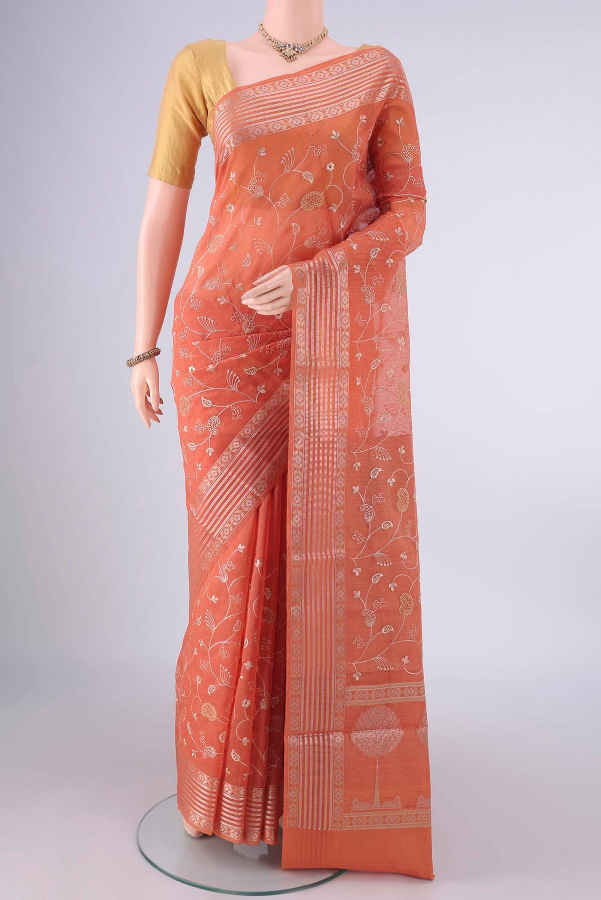 Brick Orange Blended Kota Cotton Saree with Embroidery on the body and Zari Border.  displayed on a mannequin