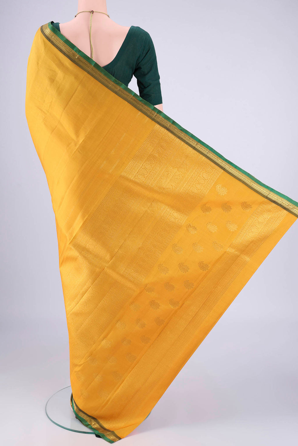 Flat view of Mustard Kanjivaram Silk Saree with Plain Body and Zari Border. 