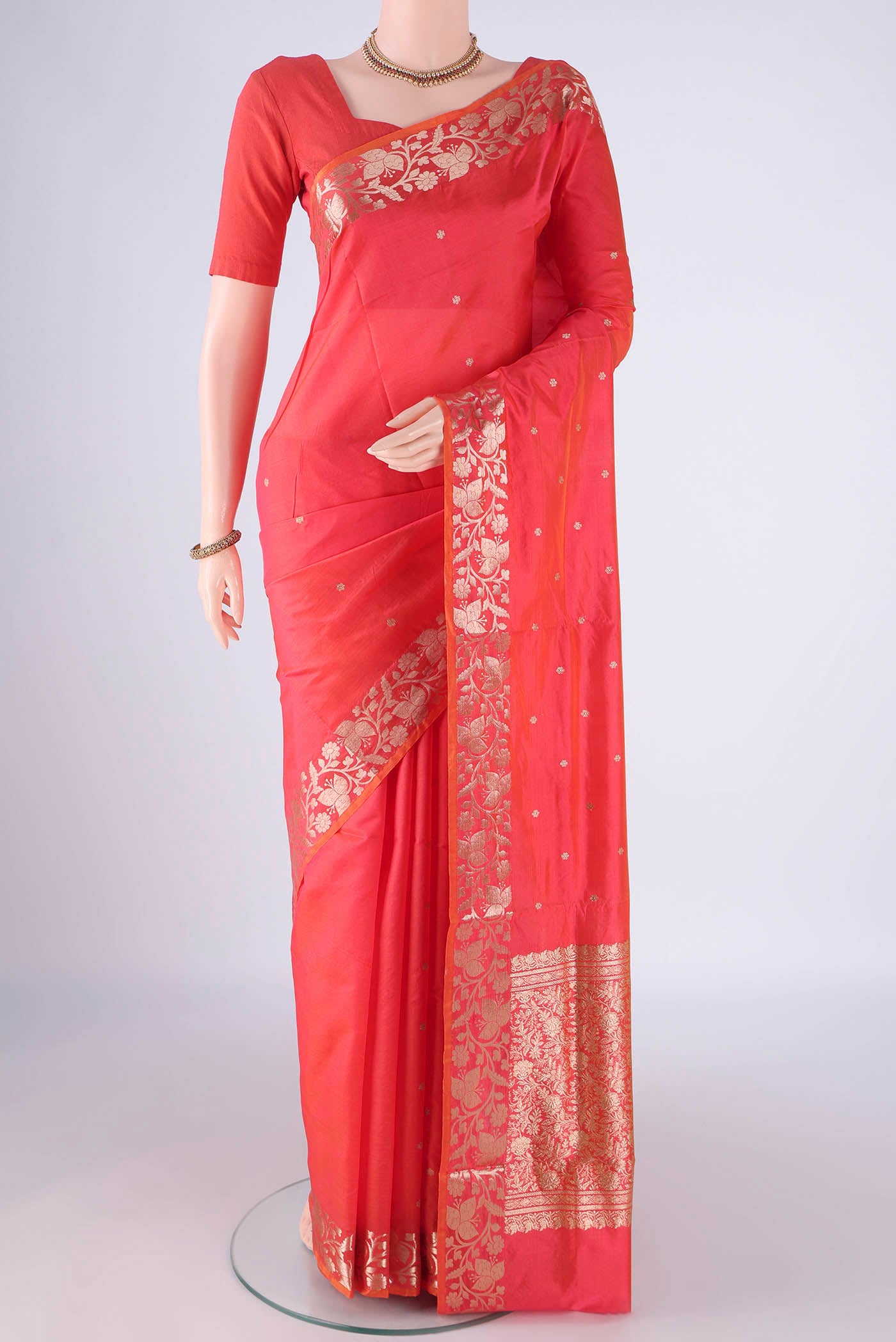 Orange Dual Tone Banarasi Katan Silk Saree with Zari Butta on the body and Zari Border.  displayed on a mannequin