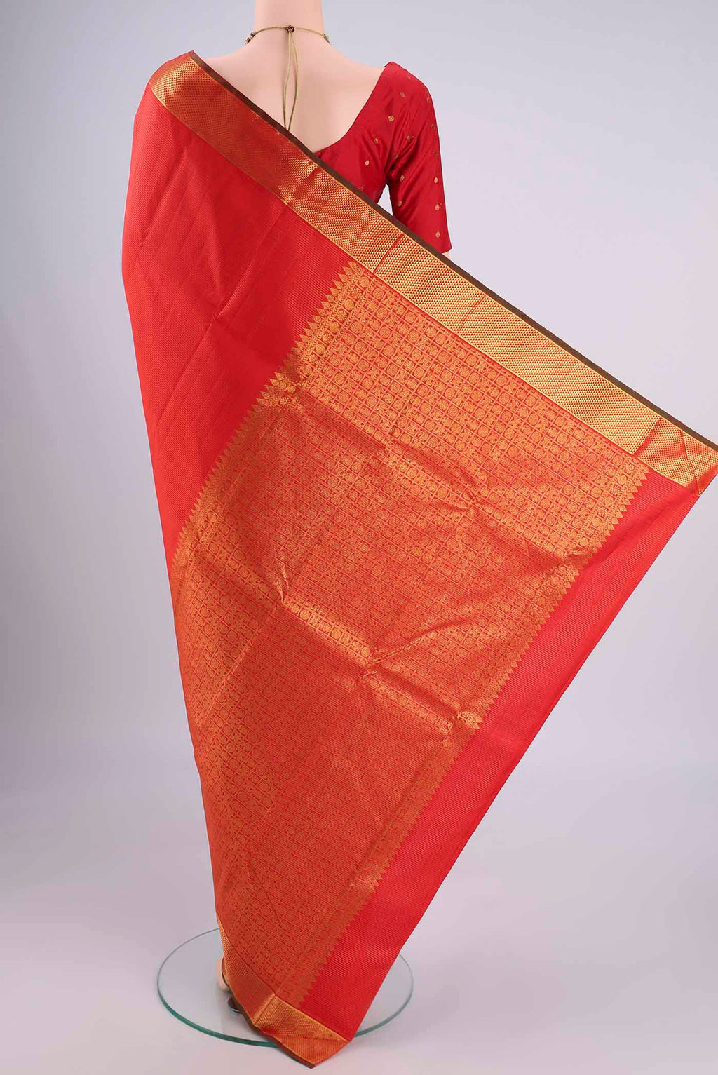 Flat view of Orange Kanjivaram Silk Saree with Stripes on the body and Zari Border. 