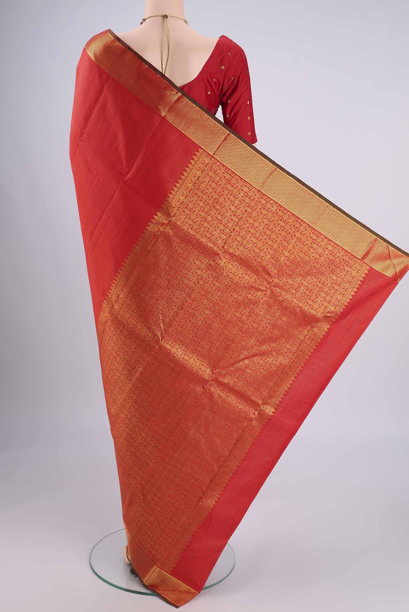 Flat view of Orange Kanjivaram Silk Saree with Stripes on the body and Zari Border. 