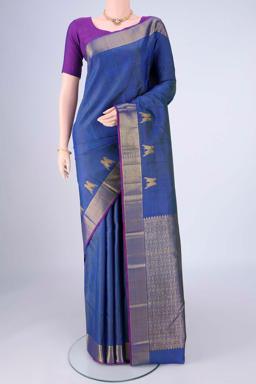 Blue Kanjivaram Silk Saree with Stripes on the body and Zari Border.  displayed on a mannequin