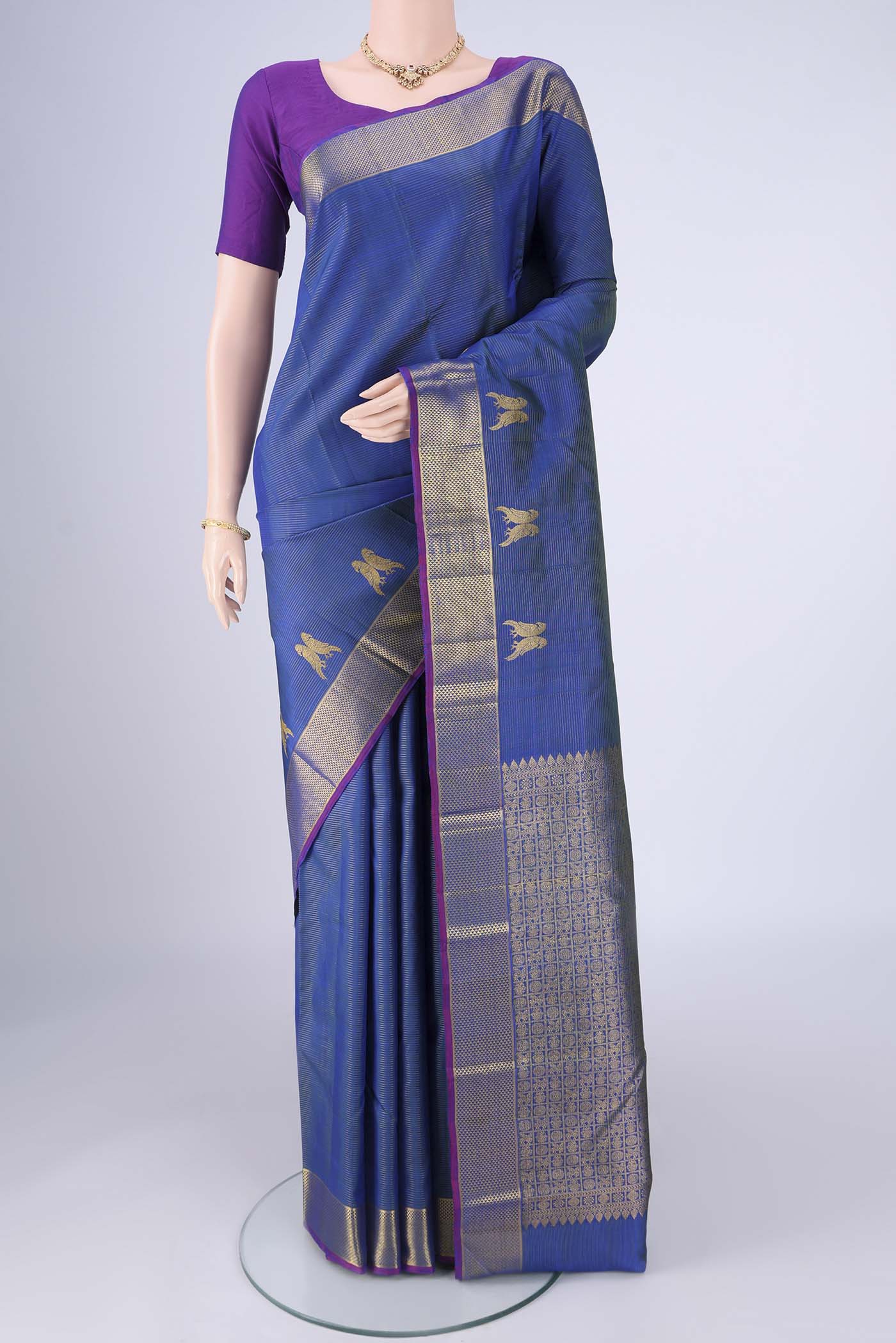 Blue Kanjivaram Silk Saree with Stripes on the body and Zari Border.  displayed on a mannequin