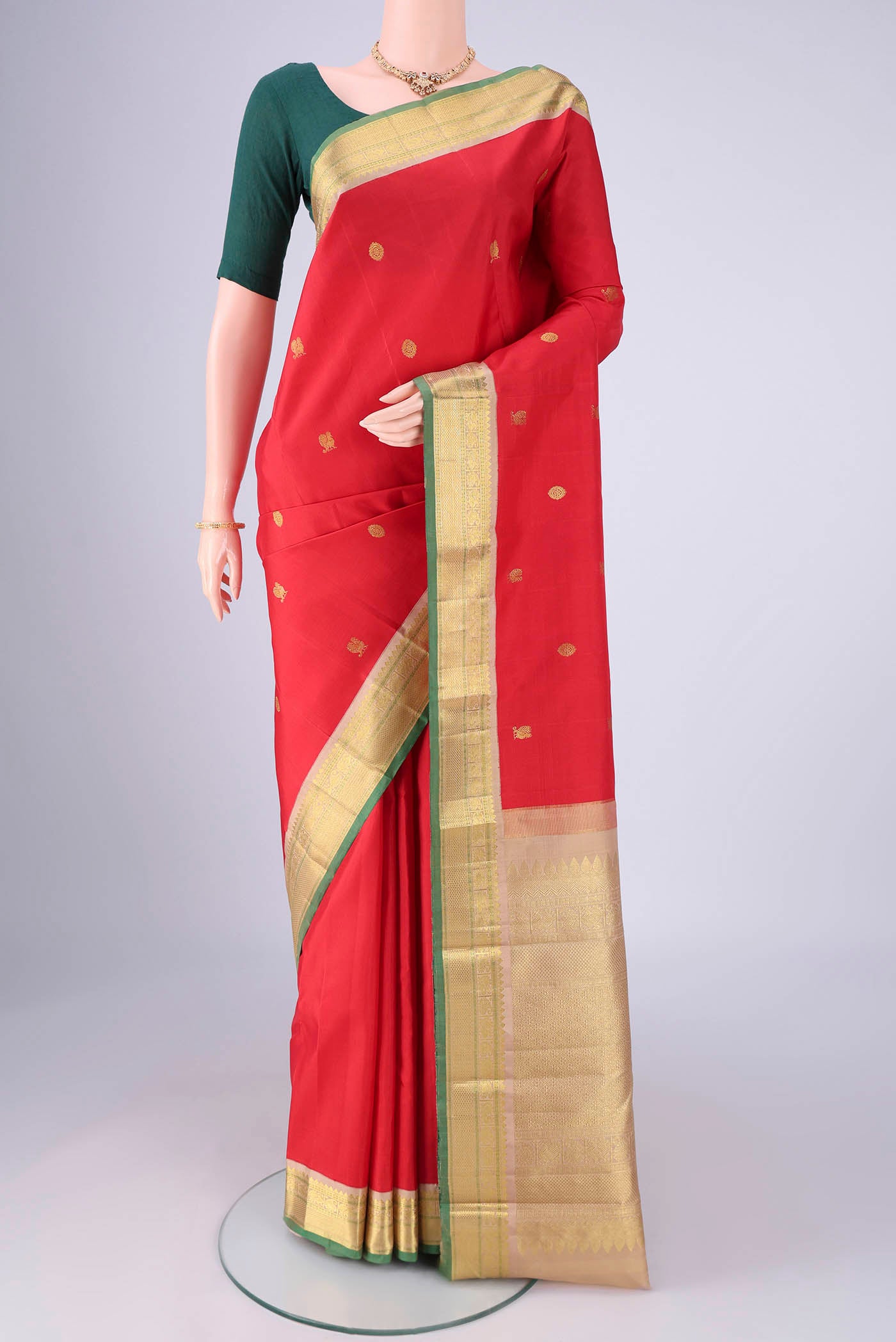 Red Kanjivaram Silk Saree with Zari Butta on the body and Zari Border.  displayed on a mannequin