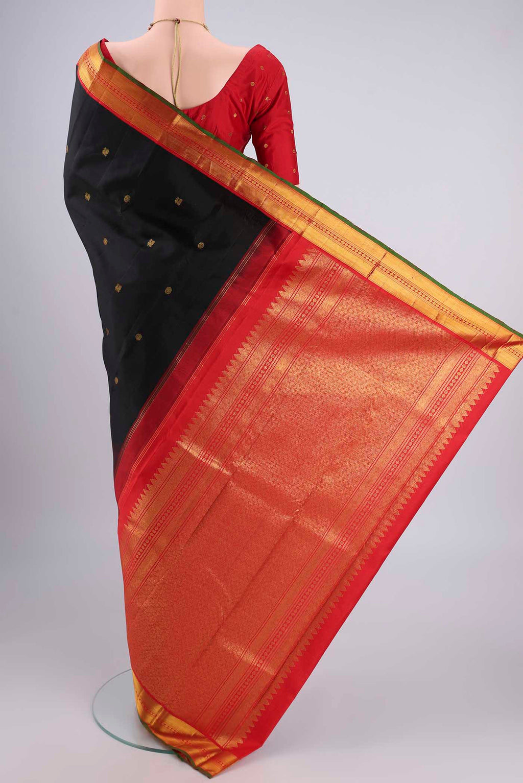 Flat view of Black Kanjivaram Silk Saree with Zari Butta on the body and Zari Border. 
