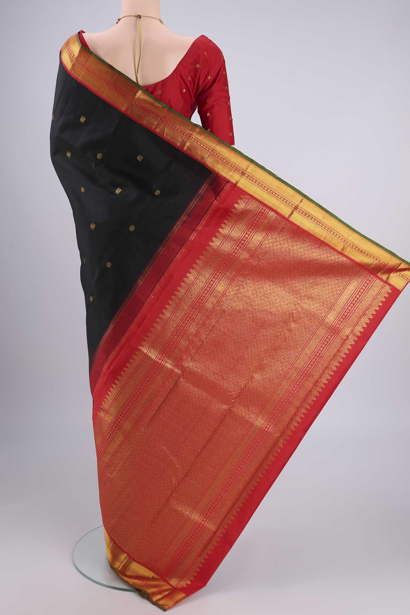 Flat view of Black Kanjivaram Silk Saree with Zari Butta on the body and Zari Border. 