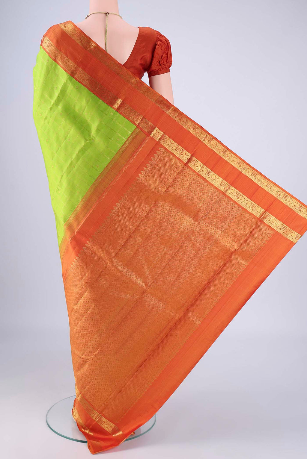Flat view of Parrot Green Kanjivaram Silk Saree with Checked design on the body and Zari Border. 
