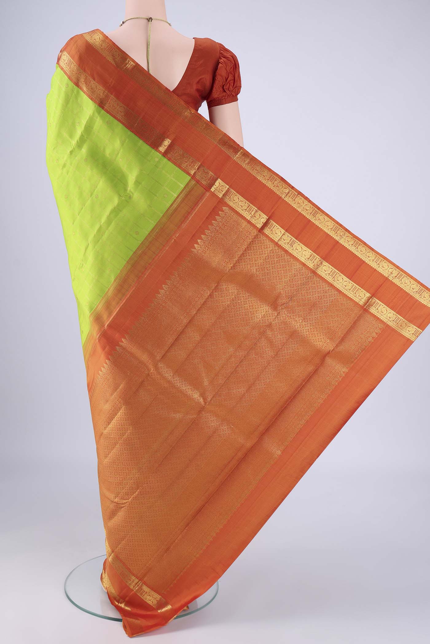 Flat view of Parrot Green Kanjivaram Silk Saree with Checked design on the body and Zari Border. 