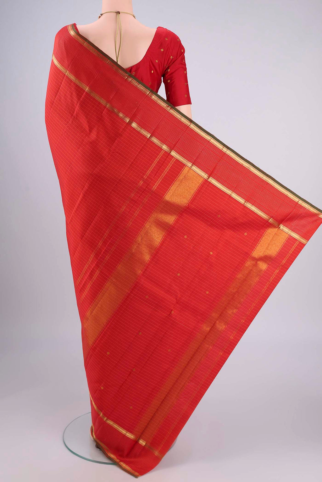 Flat view of Red Kanchipuram Silk Saree with Checked design on the body and Zari Border. 