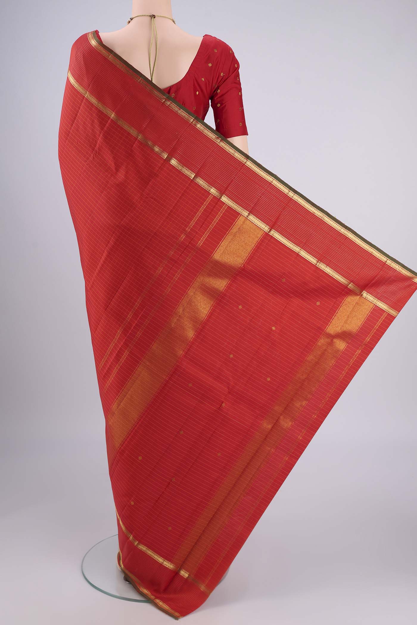 Flat view of Red Kanchipuram Silk Saree with Checked design on the body and Zari Border. 