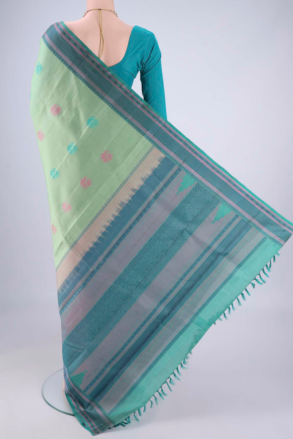 Flat view of Pista Green Kanchipuram Silk Saree with Thread Butta on the body and Thread Border. 