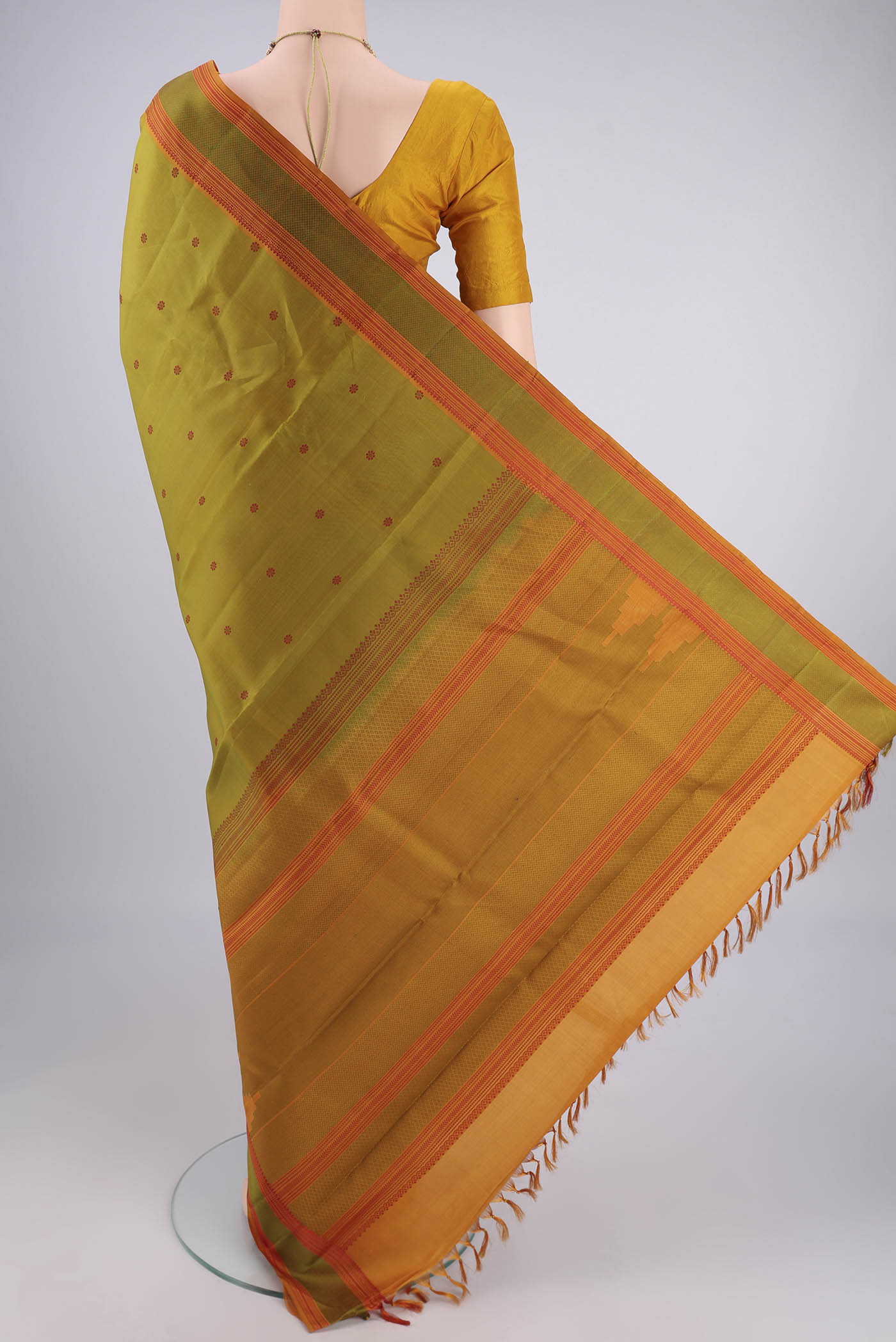 Flat view of Light Green Kanchipuram Silk Saree with Thread Butta on the body and Thread Border. 