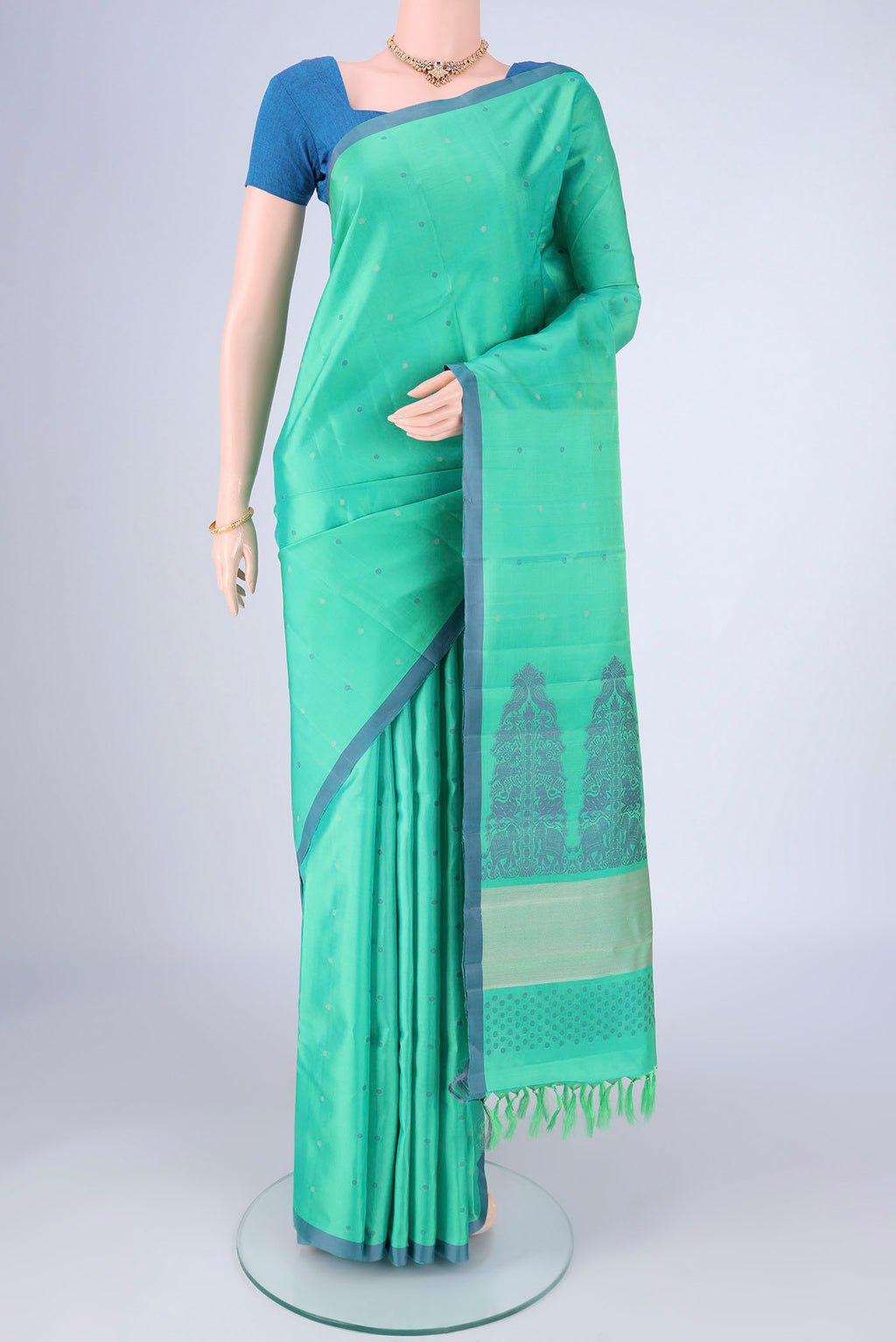 Sea Green Kanjivaram Silk Saree with Thread Butta on the body and Plain Border.  displayed on a mannequin