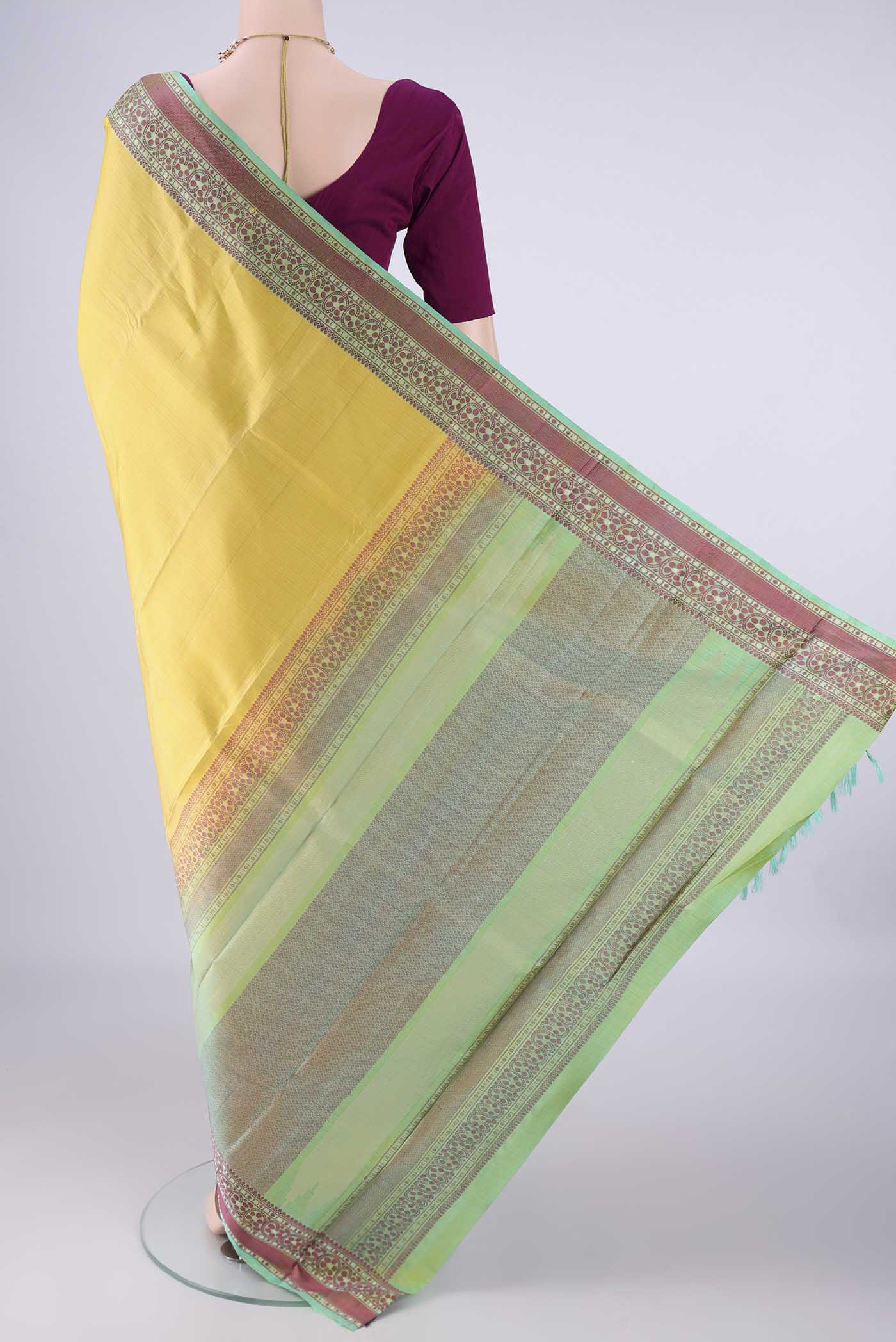 Flat view of Lemon Yellow Kanchipuram Silk Saree with Plain Body and Thread Border. 