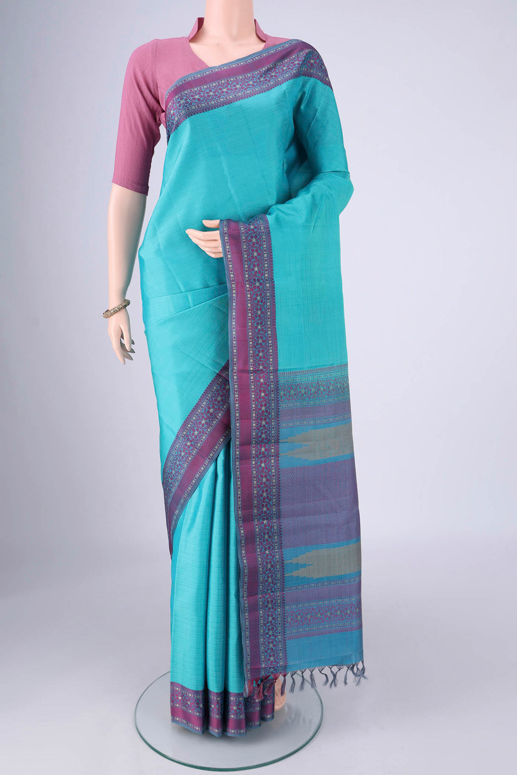 Sky Blue Kanchipuram Silk Saree with Plain Body and Thread Border.  displayed on a mannequin