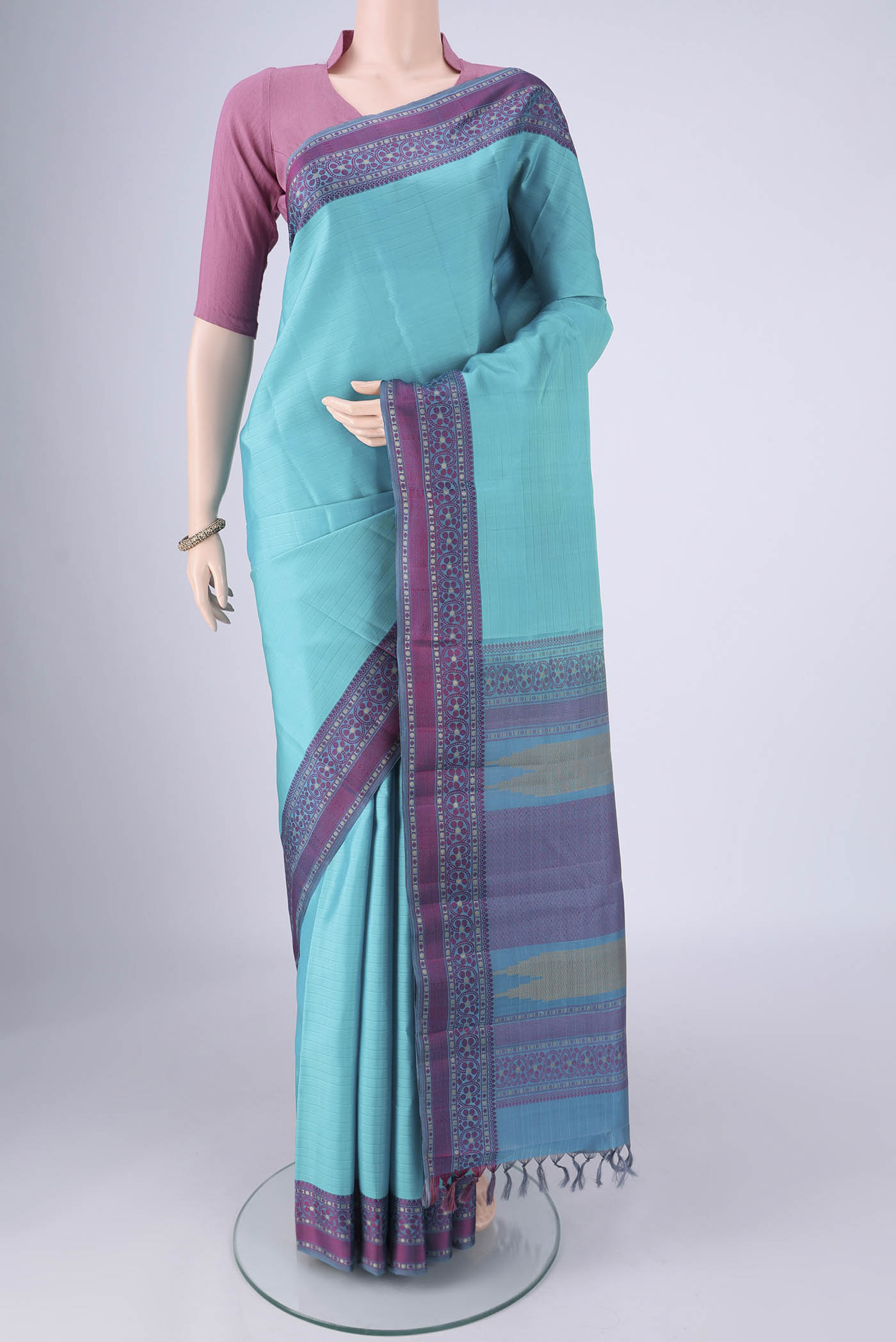 Sky Blue Kanchipuram Silk Saree with Plain Body and Thread Border.  displayed on a mannequin