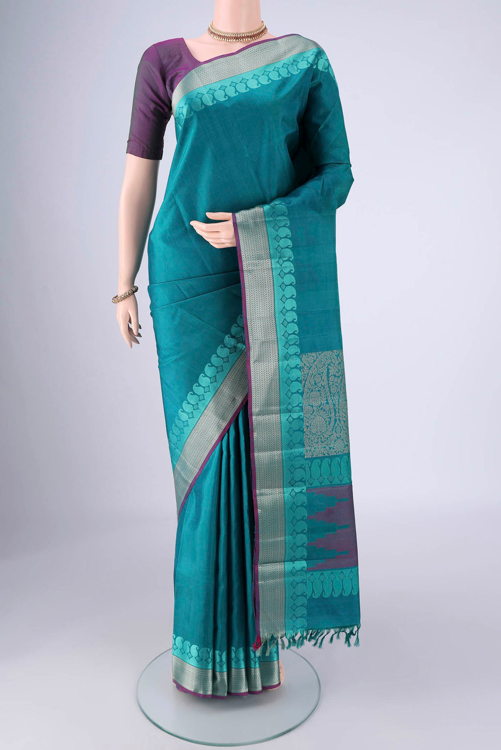 Sea Green Kanchipuram Silk Saree with Plain Body and Thread Border.  displayed on a mannequin