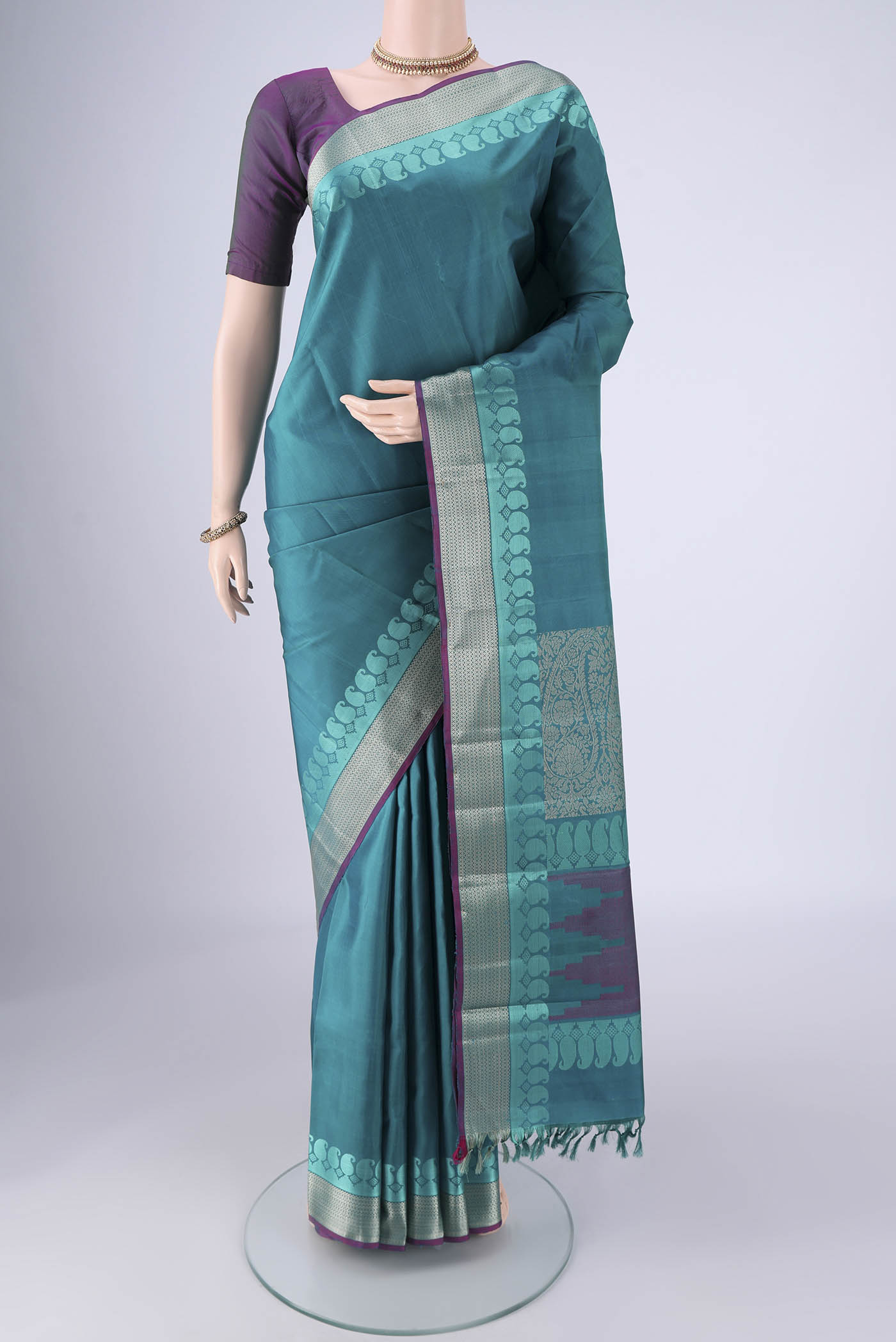 Sea Green Kanchipuram Silk Saree with Plain Body and Thread Border.  displayed on a mannequin