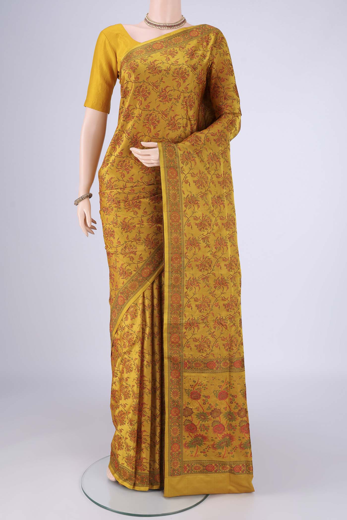 Yellow Banarasi Tanchoi Silk Saree with Jacquard design on the body and Temple Thread Border.  displayed on a mannequin