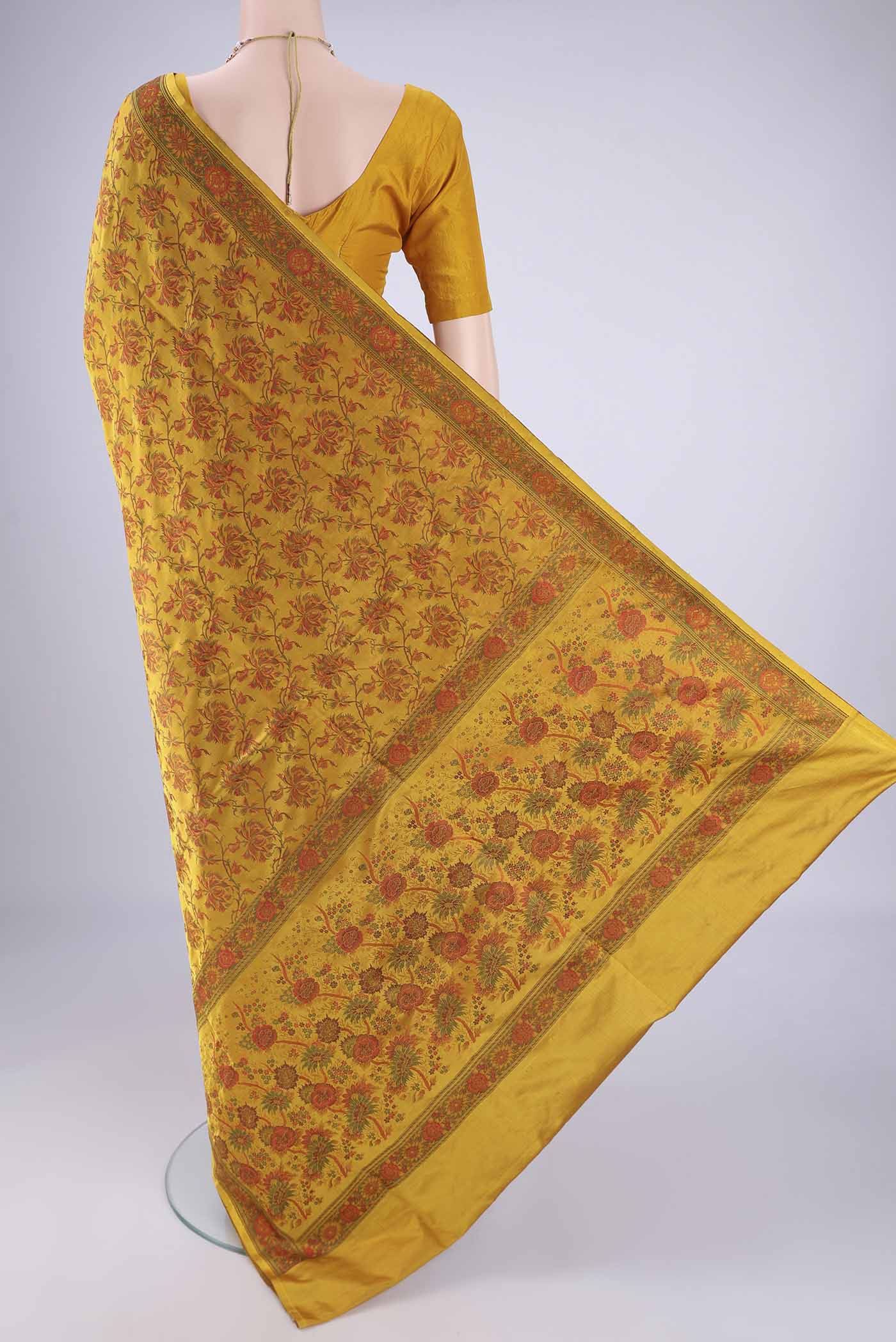 Flat view of Yellow Banarasi Tanchoi Silk Saree with Jacquard design on the body and Temple Thread Border. 