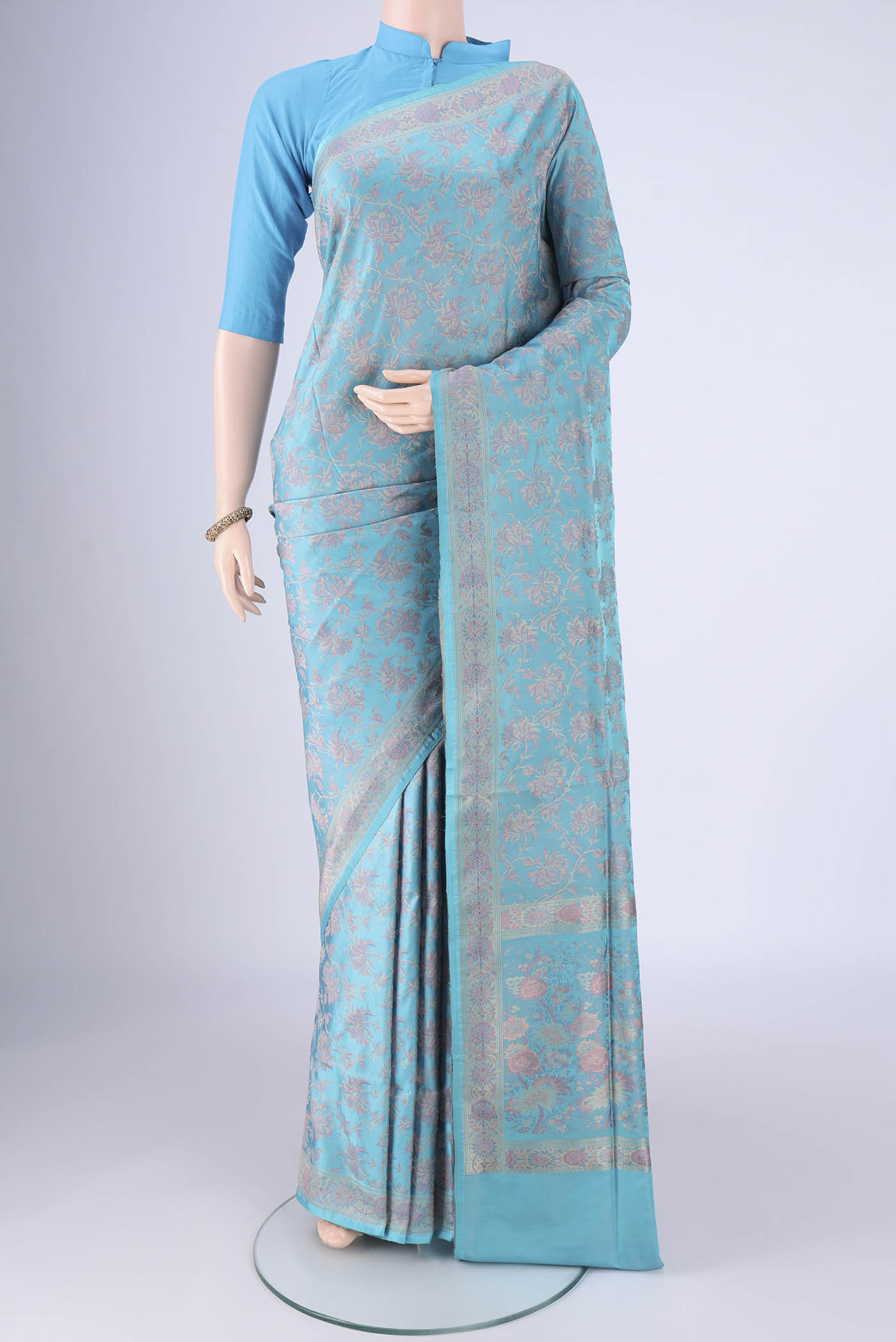 Sky Blue Banarasi Tanchoi Silk Saree with Jacquard design on the body and Thread Border.  displayed on a mannequin