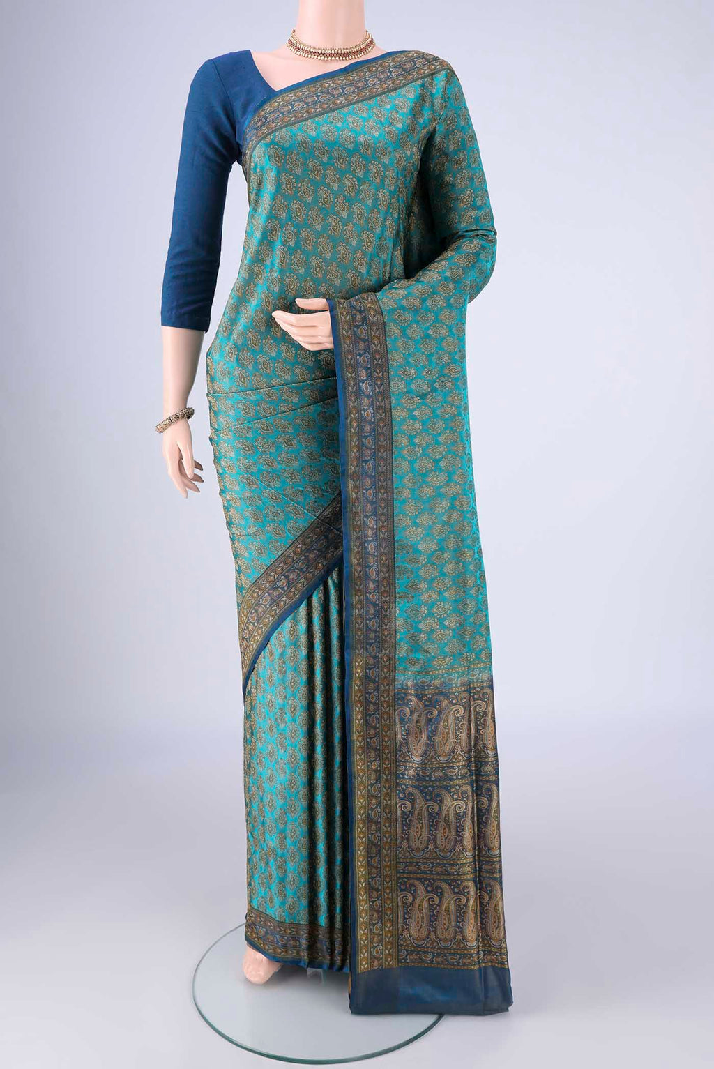 Turquoise Banarasi Tanchoi Silk Saree with Jacquard design on the body and Thread Border.  displayed on a mannequin