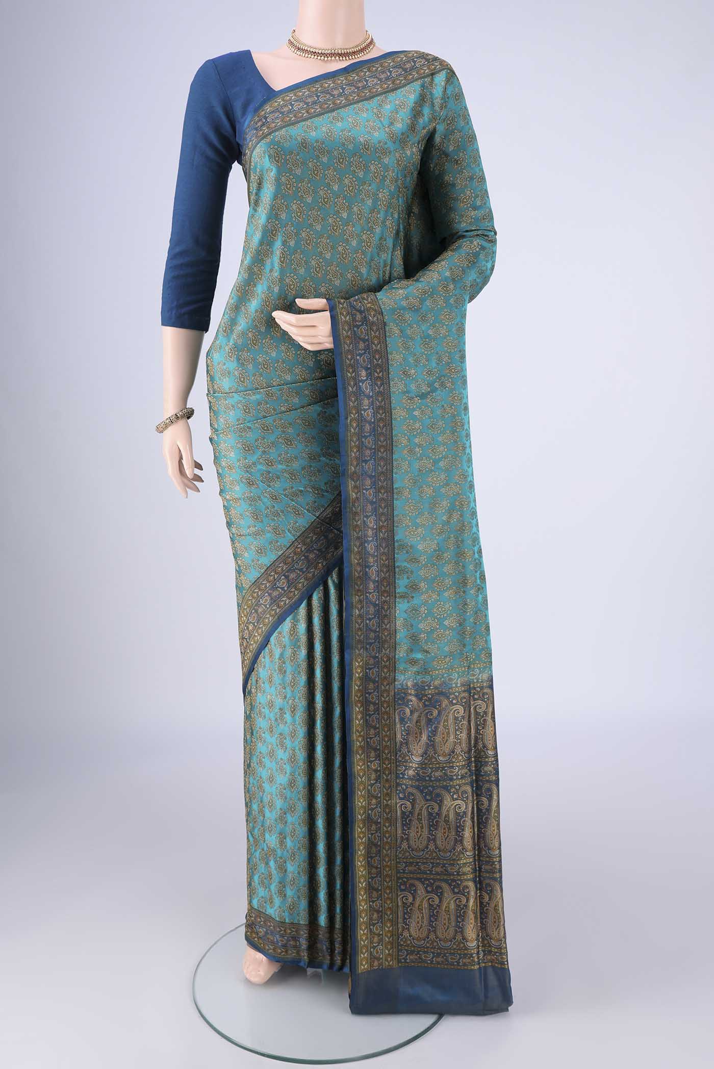 Turquoise Banarasi Tanchoi Silk Saree with Jacquard design on the body and Thread Border.  displayed on a mannequin