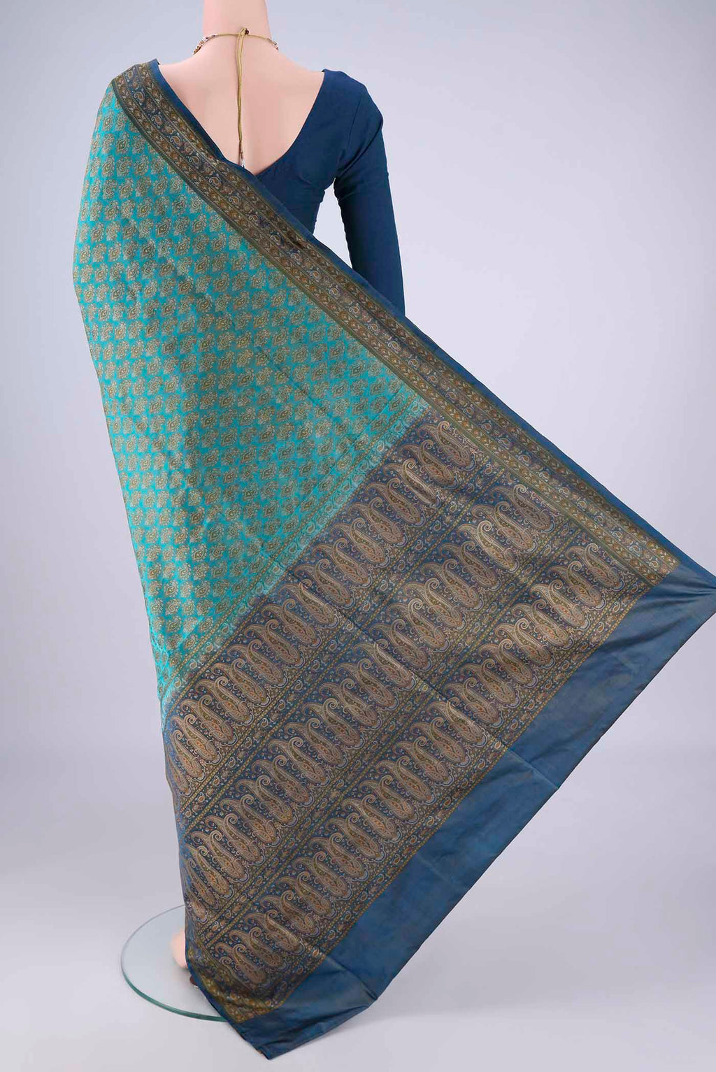 Flat view of Turquoise Banarasi Tanchoi Silk Saree with Jacquard design on the body and Thread Border. 
