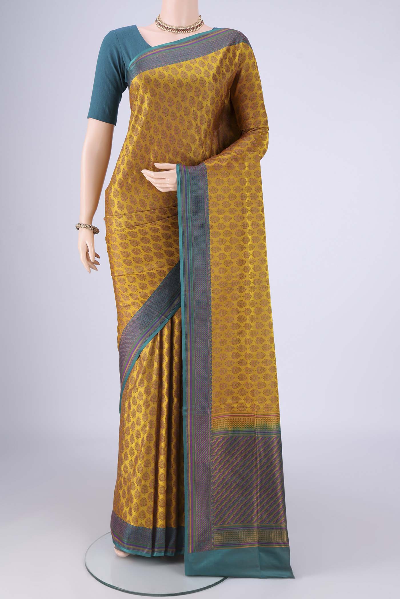 Mustard Banarasi Tanchoi Silk Saree with Jacquard design on the body and Thread Border.  displayed on a mannequin