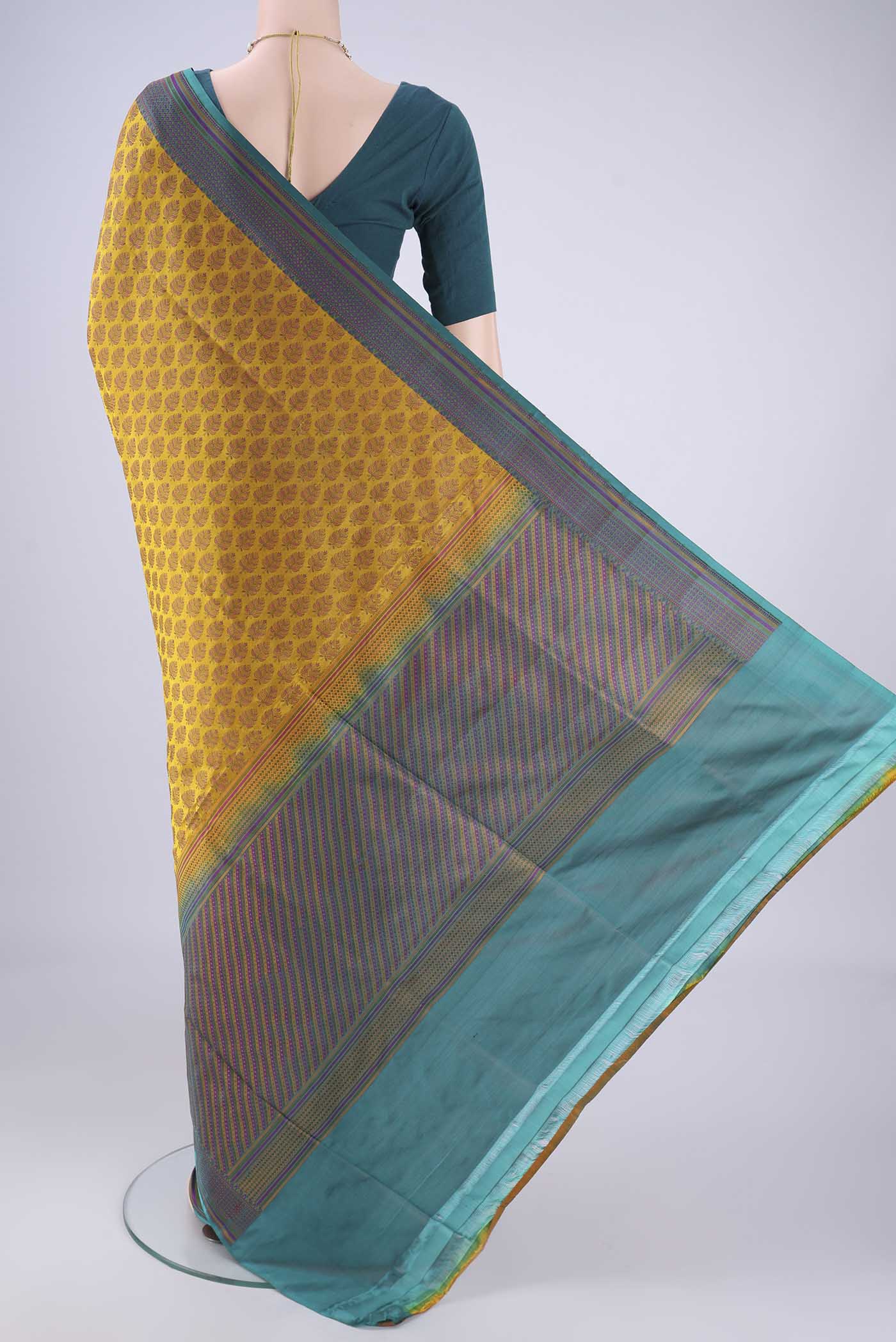 Flat view of Mustard Banarasi Tanchoi Silk Saree with Jacquard design on the body and Thread Border. 