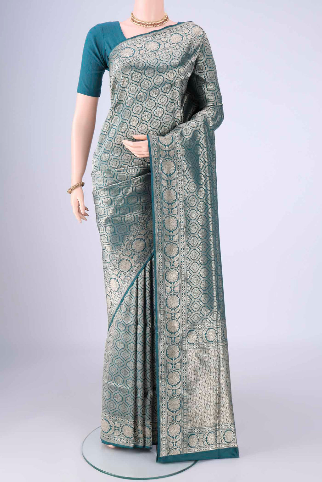 Teal Banarasi Silk Saree with Zari Brocade on the body and Zari Border.  displayed on a mannequin