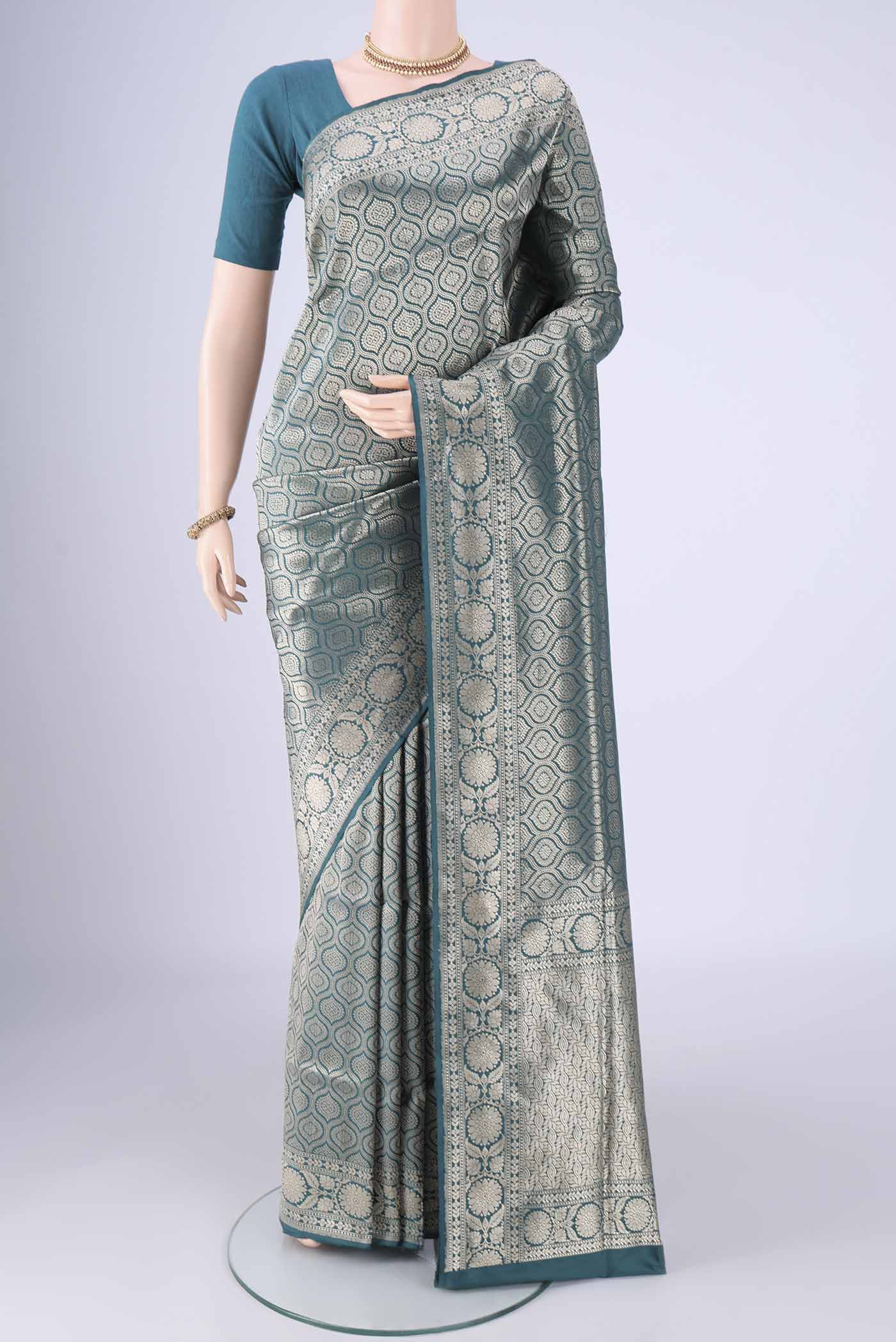 Teal Banarasi Silk Saree with Zari Brocade on the body and Zari Border.  displayed on a mannequin