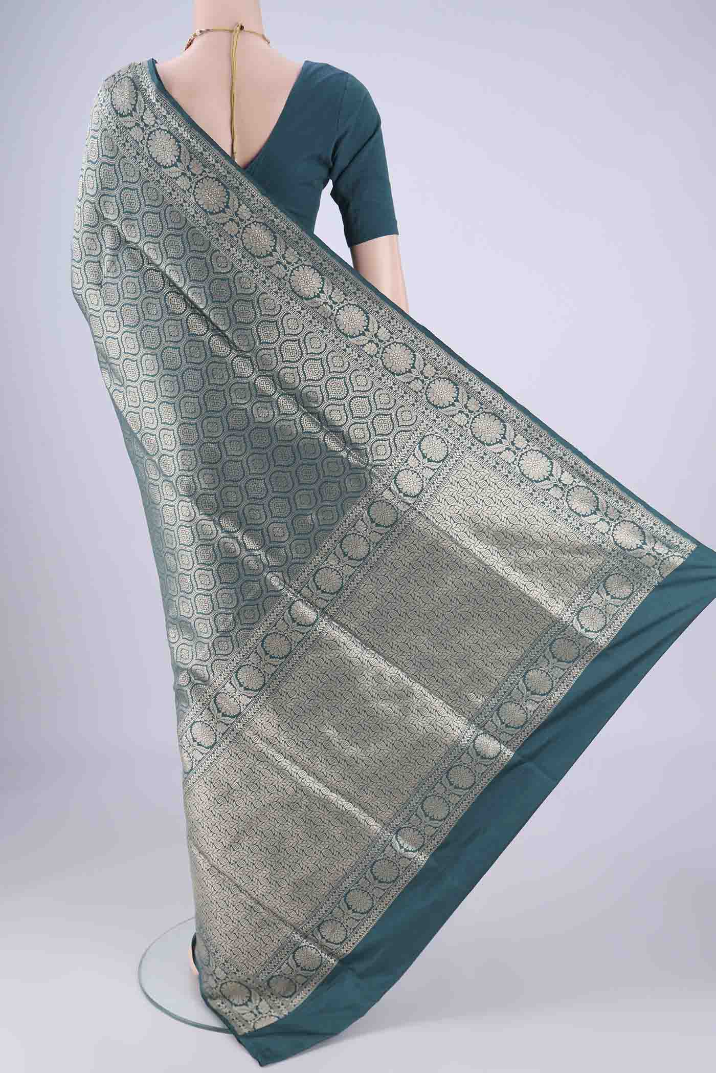 Flat view of Teal Banarasi Silk Saree with Zari Brocade on the body and Zari Border. 