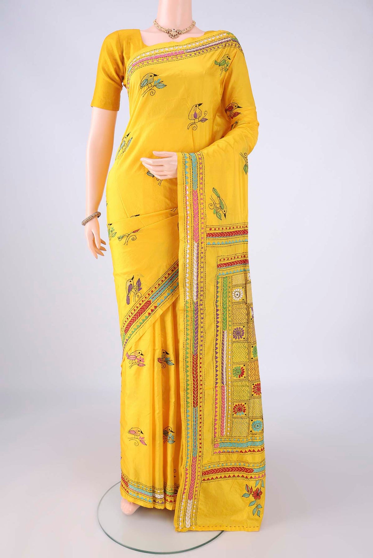 Yellow Kantha Silk Saree with Kantha Work on the body and Thread Border.  displayed on a mannequin