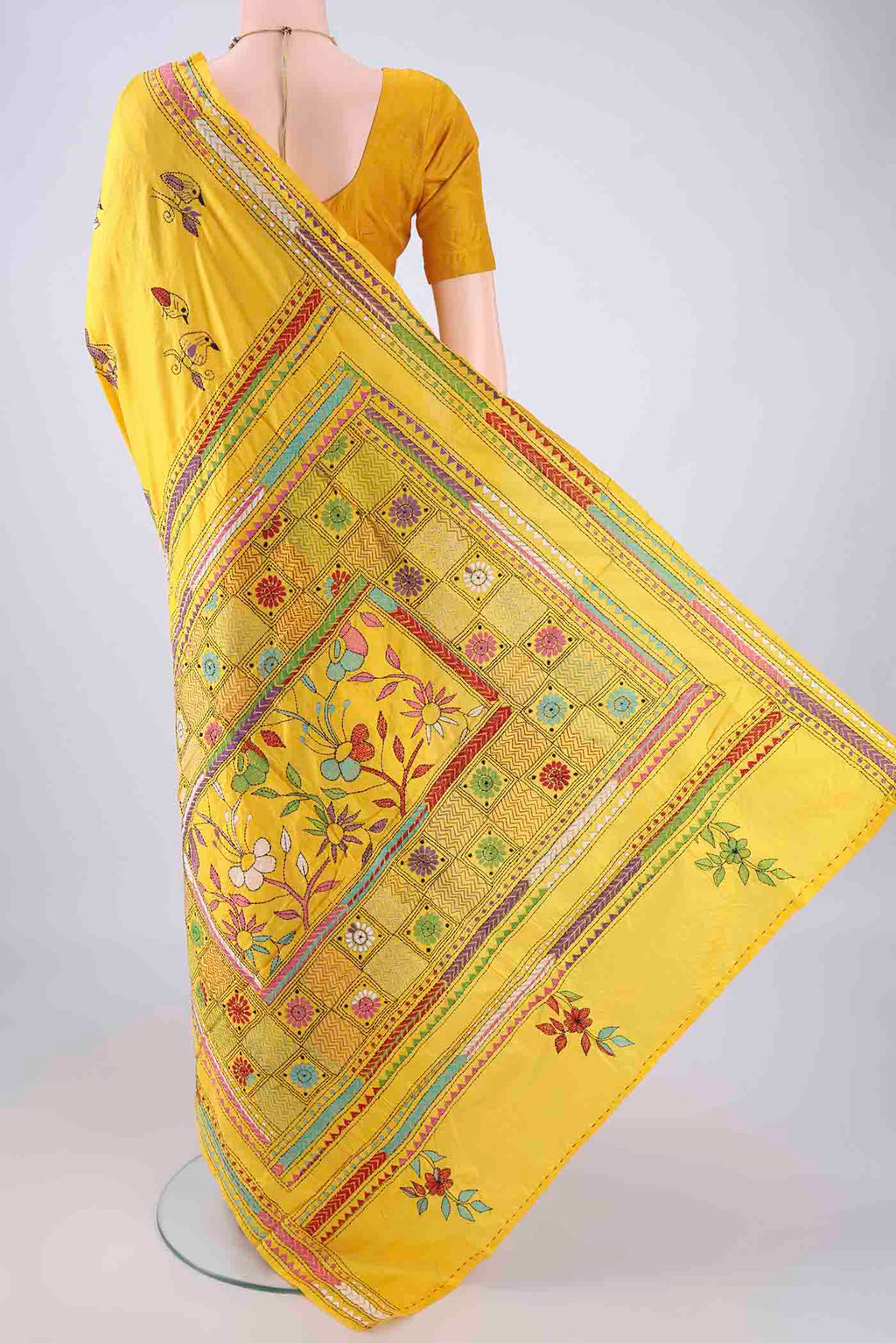 Flat view of Yellow Kantha Silk Saree with Kantha Work on the body and Thread Border. 