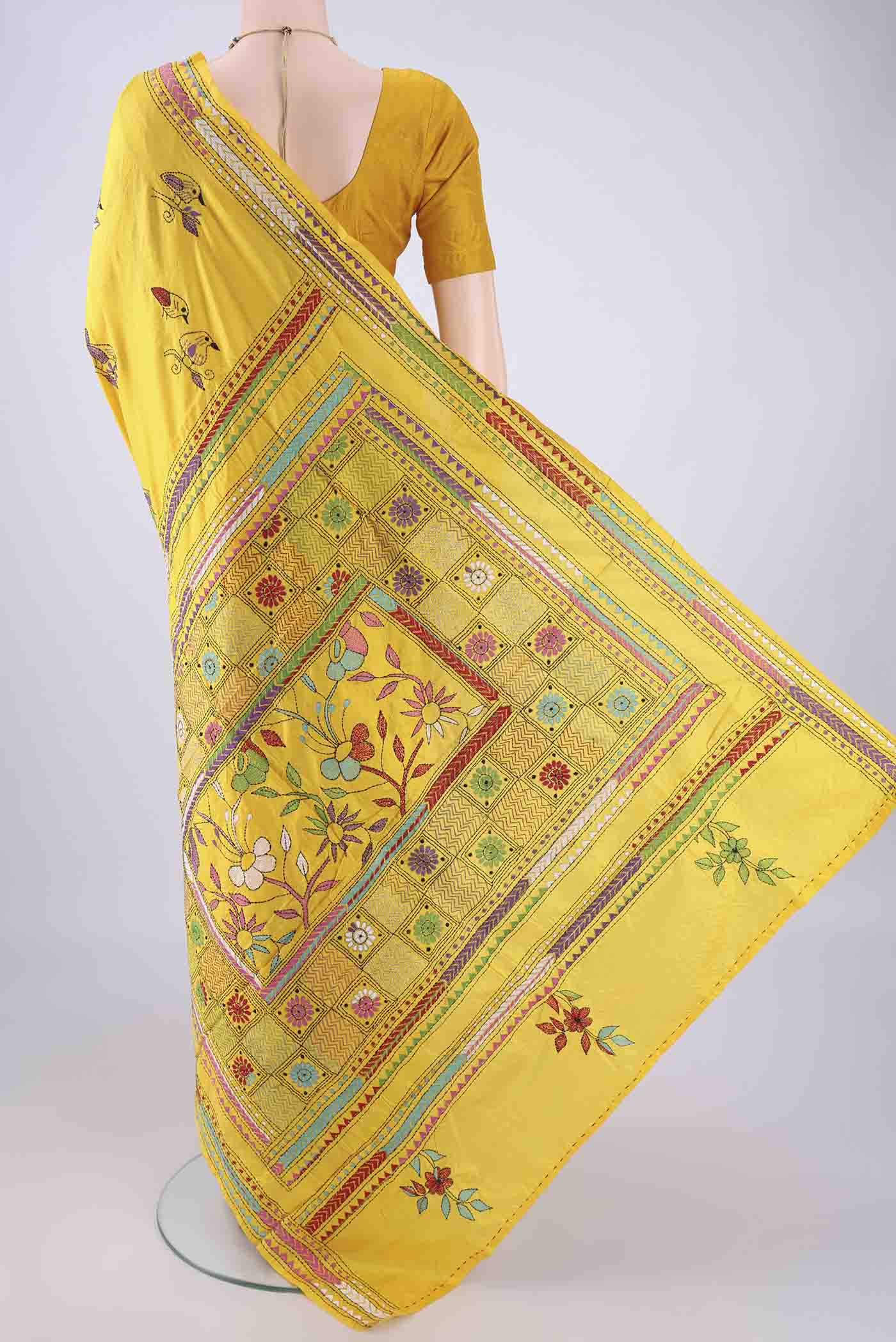 Flat view of Yellow Kantha Silk Saree with Kantha Work on the body and Thread Border. 