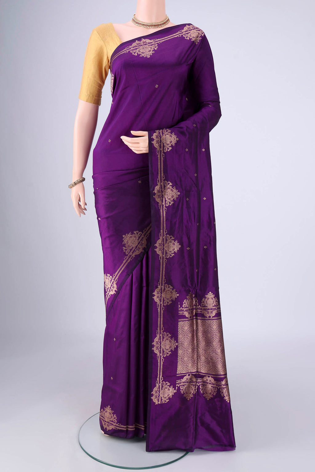 Violet Banarasi Katan Silk Saree with Zari Butta on the body and Zari Border.  displayed on a mannequin