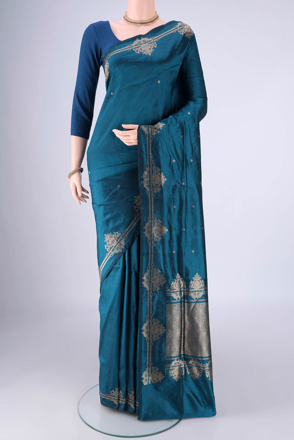 Teal Banarasi Katan Silk Saree with Zari Butta on the body and Zari Border.  displayed on a mannequin