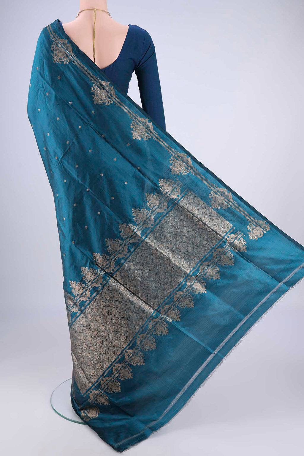 Flat view of Teal Banarasi Katan Silk Saree with Zari Butta on the body and Zari Border. 