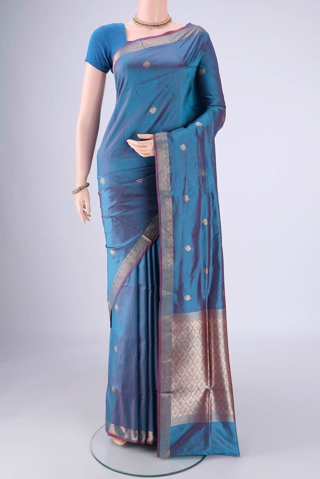 Blue Dual Tone Banarasi Katan Silk Saree with Zari Butta on the body and Zari Border.  displayed on a mannequin