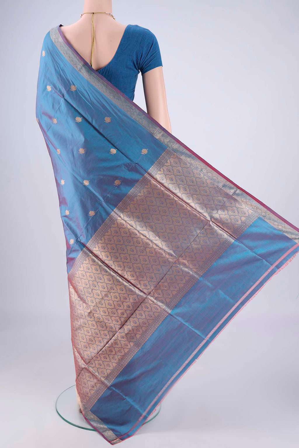 Flat view of Blue Dual Tone Banarasi Katan Silk Saree with Zari Butta on the body and Zari Border. 