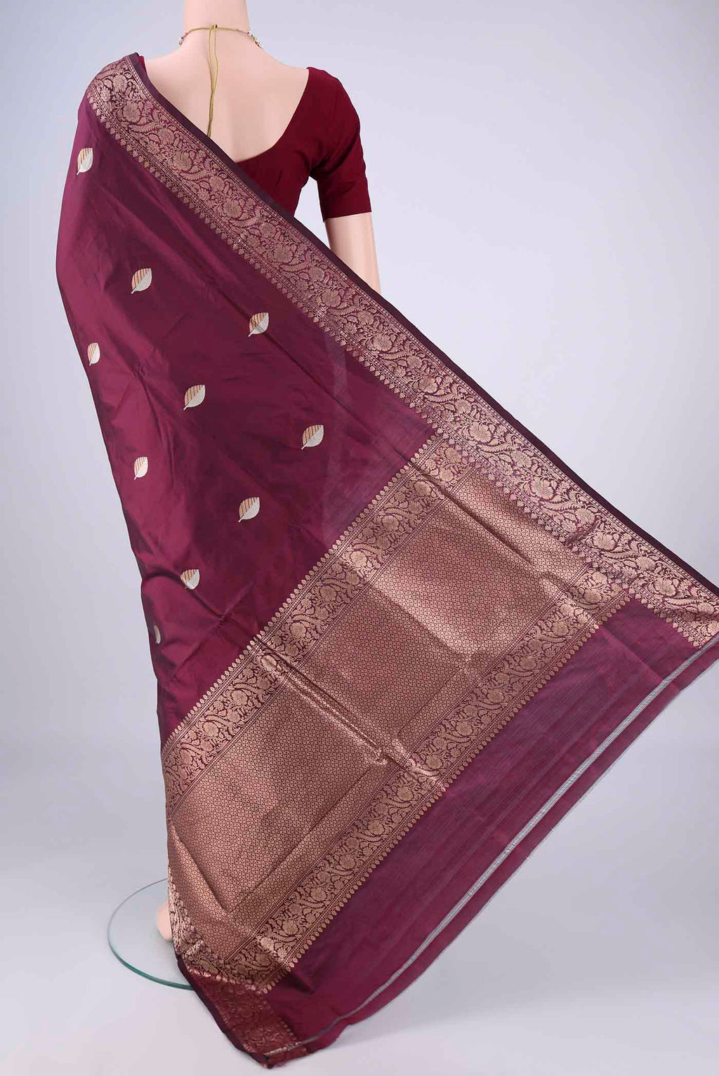 Flat view of Burgundy Banarasi Katan Silk Saree with Zari Butta on the body and Zari Border. 