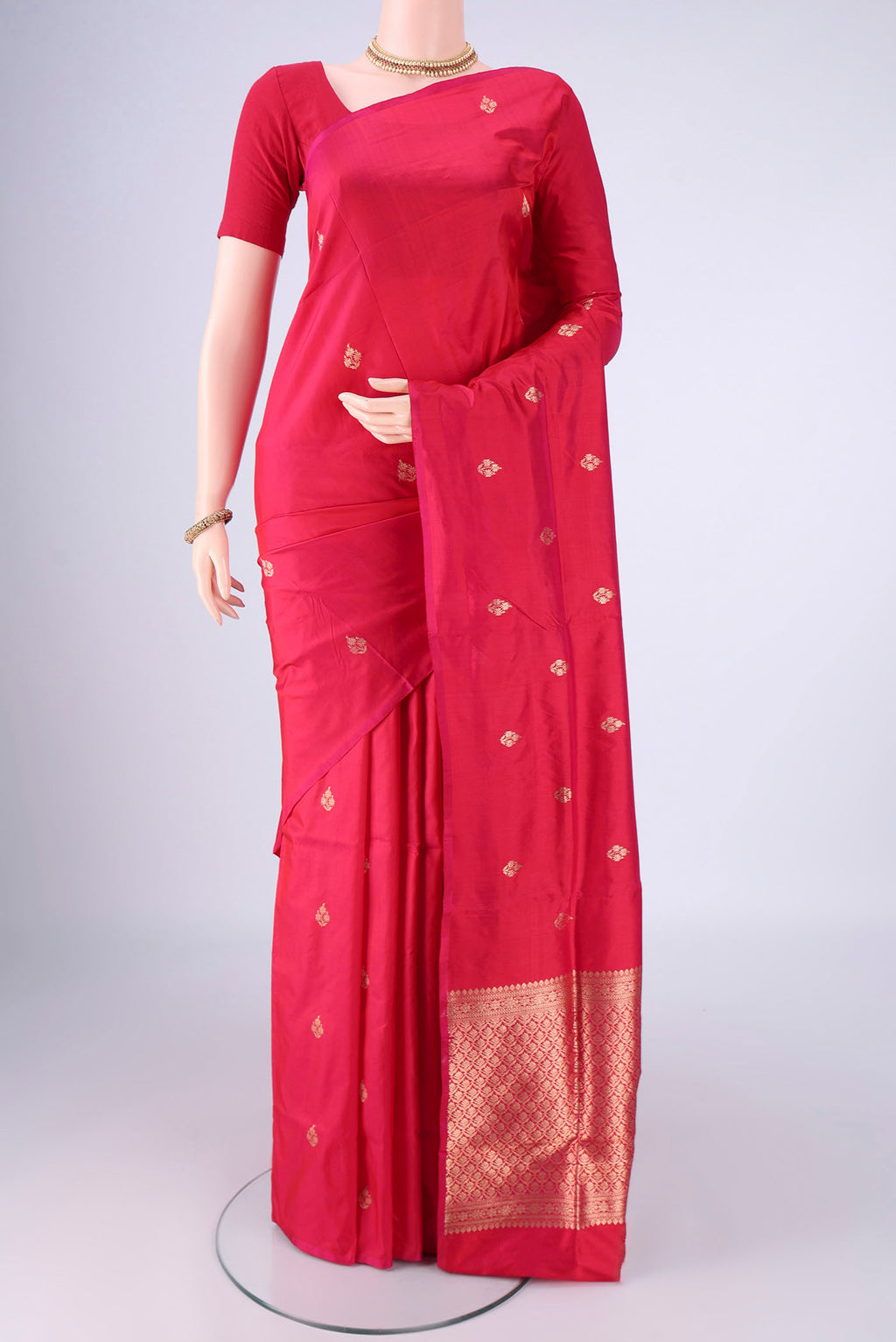 Dark Pink Banarasi Silk Saree with Zari Butta on the body and Without Border.  displayed on a mannequin