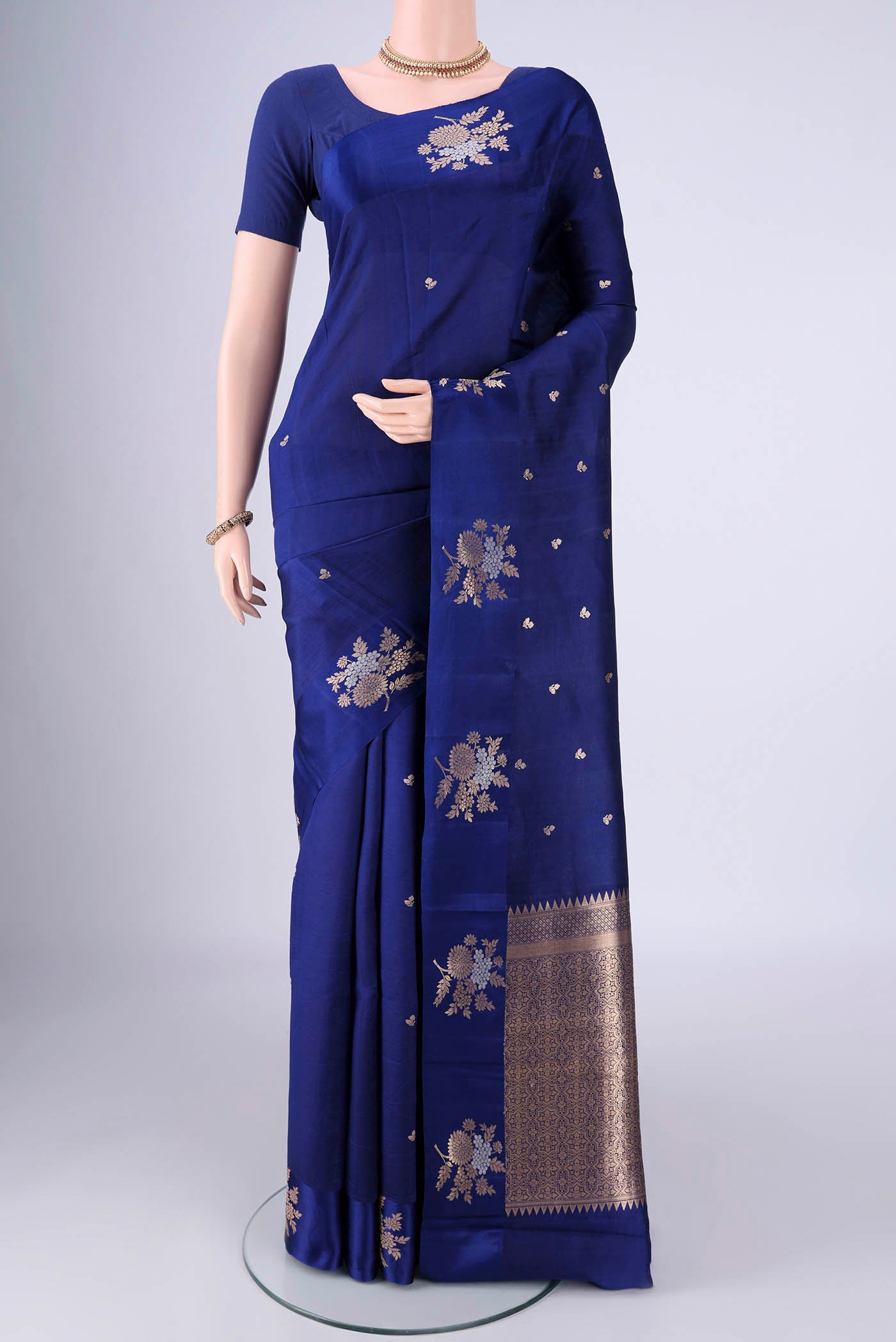 Dark Blue Banarasi Katan Silk Saree with Zari Butta on the body and Satin Border.  displayed on a mannequin