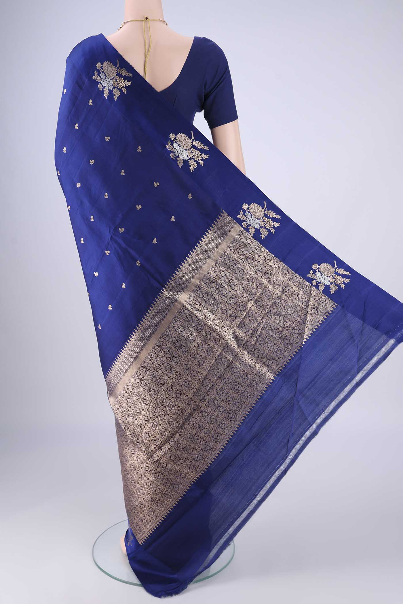 Flat view of Dark Blue Banarasi Katan Silk Saree with Zari Butta on the body and Satin Border. 