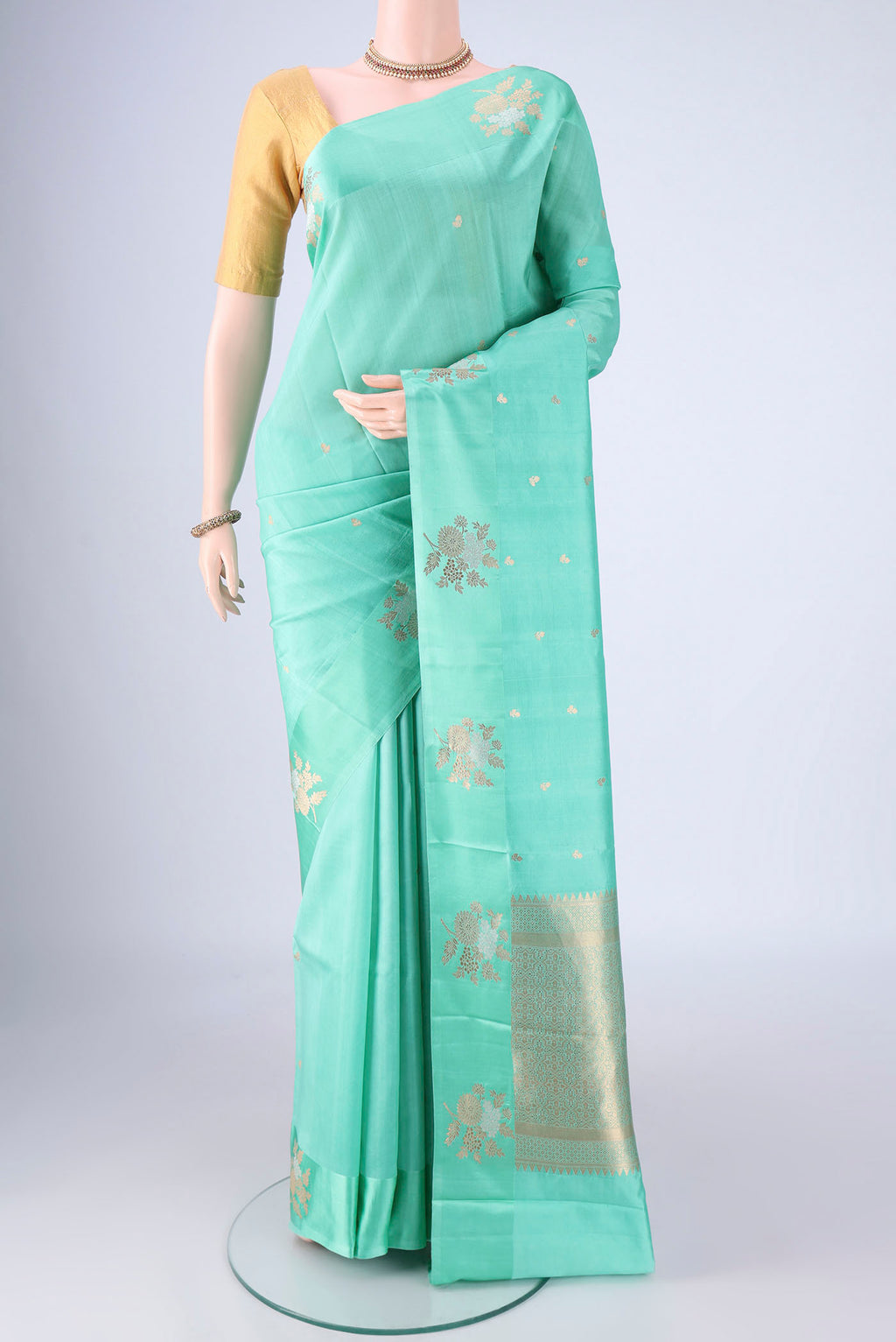 Turquoise Banarasi Katan Silk Saree with Stripes on the body and Zari Border.  displayed on a mannequin