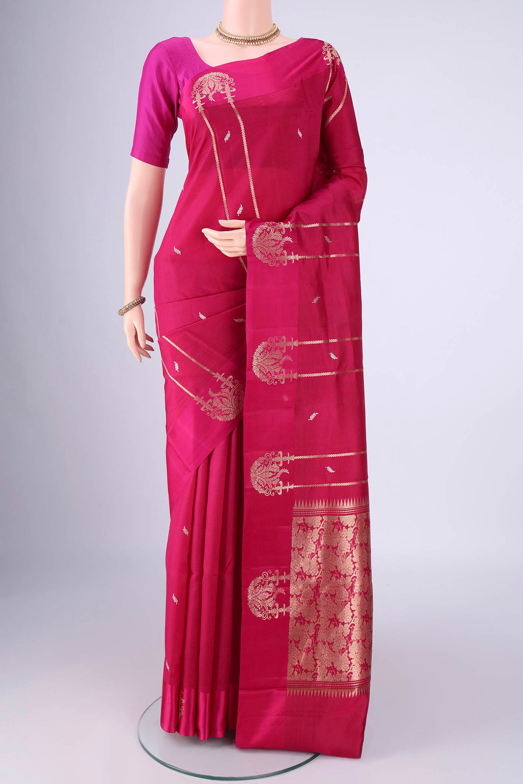 Rani Pink Banarasi Katan Silk Saree with Zari Butta on the body and Satin Border.  displayed on a mannequin